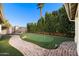 Landscaped backyard with putting green and brick pathway at 2336 Leisure World --, Mesa, AZ 85206