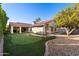 Back exterior view of the house with putting green and landscaping at 2336 Leisure World --, Mesa, AZ 85206