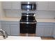 Close-up of oven and microwave with bright countertops and grey cabinets at 2355 N Cabot --, Mesa, AZ 85207