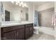 Bathroom with tub, shower, vanity with dark brown cabinets at 2511 W Queen Creek Rd # 415, Chandler, AZ 85248