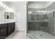 Modern bathroom with double vanity, large shower, and dark brown cabinets at 2511 W Queen Creek Rd # 415, Chandler, AZ 85248