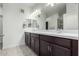 Bathroom with double sink, dark brown vanity, and modern lighting at 2511 W Queen Creek Rd # 415, Chandler, AZ 85248