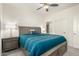 Serene bedroom with king bed, ceiling fan, and ensuite bathroom access at 2511 W Queen Creek Rd # 415, Chandler, AZ 85248