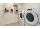 Laundry room with washer, dryer, and overhead storage at 2511 W Queen Creek Rd # 415, Chandler, AZ 85248