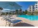 Inviting pool area with blue umbrellas and lounge chairs at 2511 W Queen Creek Rd # 415, Chandler, AZ 85248