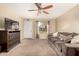 Living room with a grey couch and ceiling fan at 2526 N 22Nd Dr, Phoenix, AZ 85009