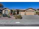 House exterior featuring a two-car garage and desert landscaping at 26646 N 46Th Pl, Cave Creek, AZ 85331