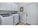 Laundry room with washer, dryer, cabinets, and utility sink at 26646 N 46Th Pl, Cave Creek, AZ 85331