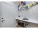 Laundry room with shelving, sink, and hanging space at 26646 N 46Th Pl, Cave Creek, AZ 85331