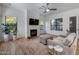 Living room with fireplace, hardwood floors, and access to backyard at 26646 N 46Th Pl, Cave Creek, AZ 85331