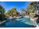 Inviting kidney-shaped pool surrounded by tropical plants at 26646 N 46Th Pl, Cave Creek, AZ 85331