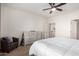 Bright bedroom with a large bed, dresser, and comfortable chair at 27606 W Tonopah Dr, Buckeye, AZ 85396