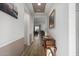 Hallway with wood floors and view into living room at 27606 W Tonopah Dr, Buckeye, AZ 85396