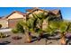 Front view of house with palm trees and gravel at 27606 W Tonopah Dr, Buckeye, AZ 85396