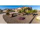 Landscaped front yard with rock, plants, and trees at 27606 W Tonopah Dr, Buckeye, AZ 85396