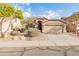 One-story house with beige exterior, two-car garage, and landscaped front yard at 2805 N 111Th Dr, Avondale, AZ 85392