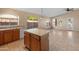 Bright kitchen with island, tile floors, and ample cabinetry at 2805 N 111Th Dr, Avondale, AZ 85392