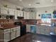 Well-equipped kitchen with white cabinets, tile backsplash, and wood floors at 302 E Beech Ave, Casa Grande, AZ 85122