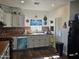 Bright kitchen featuring white cabinets, tile backsplash and a convenient pantry at 302 E Beech Ave, Casa Grande, AZ 85122