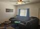 Relaxing living room with sectional sofa, wood floors, and ample natural light at 302 E Beech Ave, Casa Grande, AZ 85122