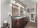 Double vanity bathroom with dark wood cabinets at 3036 W Gail Rd, Phoenix, AZ 85029