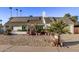 Single story house with solar panels and gravel yard at 3036 W Gail Rd, Phoenix, AZ 85029