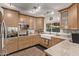 Modern kitchen with light wood cabinets and granite countertops at 3036 W Gail Rd, Phoenix, AZ 85029