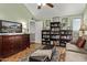 Relaxing living room featuring a large TV and ample bookshelf storage at 3036 W Gail Rd, Phoenix, AZ 85029