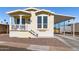 Bright yellow single-wide manufactured home with covered carport and small front porch at 305 S Val Vista Dr # 71, Mesa, AZ 85204