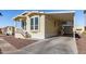 Front view of a yellow manufactured home with carport and landscaping at 305 S Val Vista Dr # 71, Mesa, AZ 85204