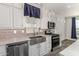 Kitchen with farmhouse sink, stainless steel appliances, and white cabinets at 305 S Val Vista Dr # 71, Mesa, AZ 85204