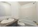 Bathroom with tub, toilet and vanity with dark countertop at 3100 W Quail Rd, Eloy, AZ 85131