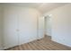 Simple bedroom with wood-look floors and an additional closet at 3100 W Quail Rd, Eloy, AZ 85131