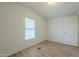 Small bedroom with wood-look floors and a window with blinds at 3100 W Quail Rd, Eloy, AZ 85131