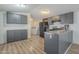 Galley kitchen with gray cabinets and island at 3100 W Quail Rd, Eloy, AZ 85131