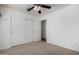 Bright bedroom with sliding door closet and ceiling fan at 34717 N Picket Post Dr, Queen Creek, AZ 85142