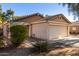 Tan house with a two-car garage and desert landscaping at 34717 N Picket Post Dr, Queen Creek, AZ 85142