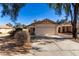 Tan house with a two-car garage and desert landscaping at 34717 N Picket Post Dr, Queen Creek, AZ 85142