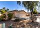 Tan house with a two-car garage and desert landscaping at 34717 N Picket Post Dr, Queen Creek, AZ 85142