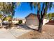 Tan house with a two-car garage and desert landscaping at 34717 N Picket Post Dr, Queen Creek, AZ 85142