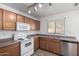 Bright kitchen with oak cabinets, white appliances, and tile floors at 34717 N Picket Post Dr, Queen Creek, AZ 85142