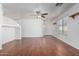 Bright living room featuring hardwood floors and ceiling fan at 34717 N Picket Post Dr, Queen Creek, AZ 85142