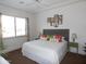 King-size bed, large window, and ceiling fan in bedroom at 4241 N Pebble Creek Pkwy # 13, Goodyear, AZ 85395