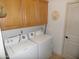 Laundry room with washer, dryer, and cabinets at 4241 N Pebble Creek Pkwy # 13, Goodyear, AZ 85395