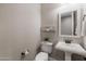 Elegant powder room with pedestal sink, toilet, and mirror at 4552 S Flare --, Mesa, AZ 85212