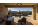 Relaxing covered patio overlooking a sparkling pool and spa at 4552 S Flare --, Mesa, AZ 85212