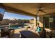 Outdoor living space with a covered patio and stunning pool views at 4552 S Flare --, Mesa, AZ 85212