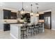 Modern kitchen with dark cabinetry, granite countertops, and island at 4552 S Flare --, Mesa, AZ 85212