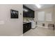 Laundry room with dark cabinets, sink, and washer/dryer at 4552 S Flare --, Mesa, AZ 85212