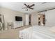 Main bedroom with a large bed, dresser, and a barn door leading to the bathroom at 4552 S Flare --, Mesa, AZ 85212